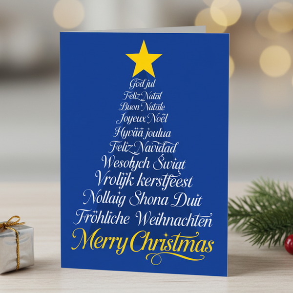 Blue Christmas card with white text and a yellow star, featuring greetings in multiple languages.